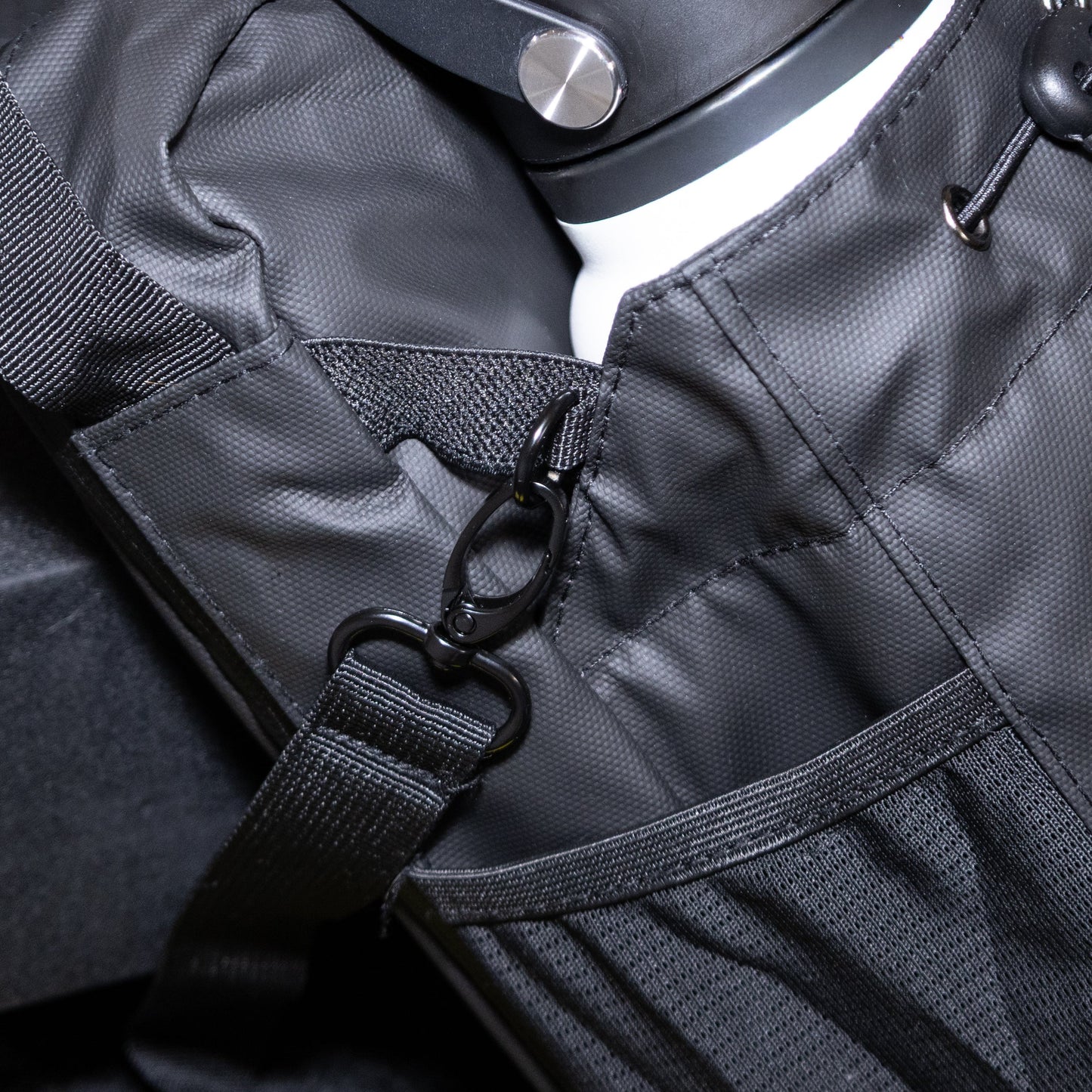 Black waterproof gym bag with reflective accents on a dark background